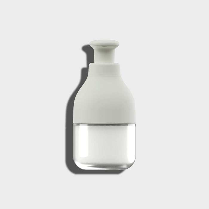 White soap dispenser on a light gray background